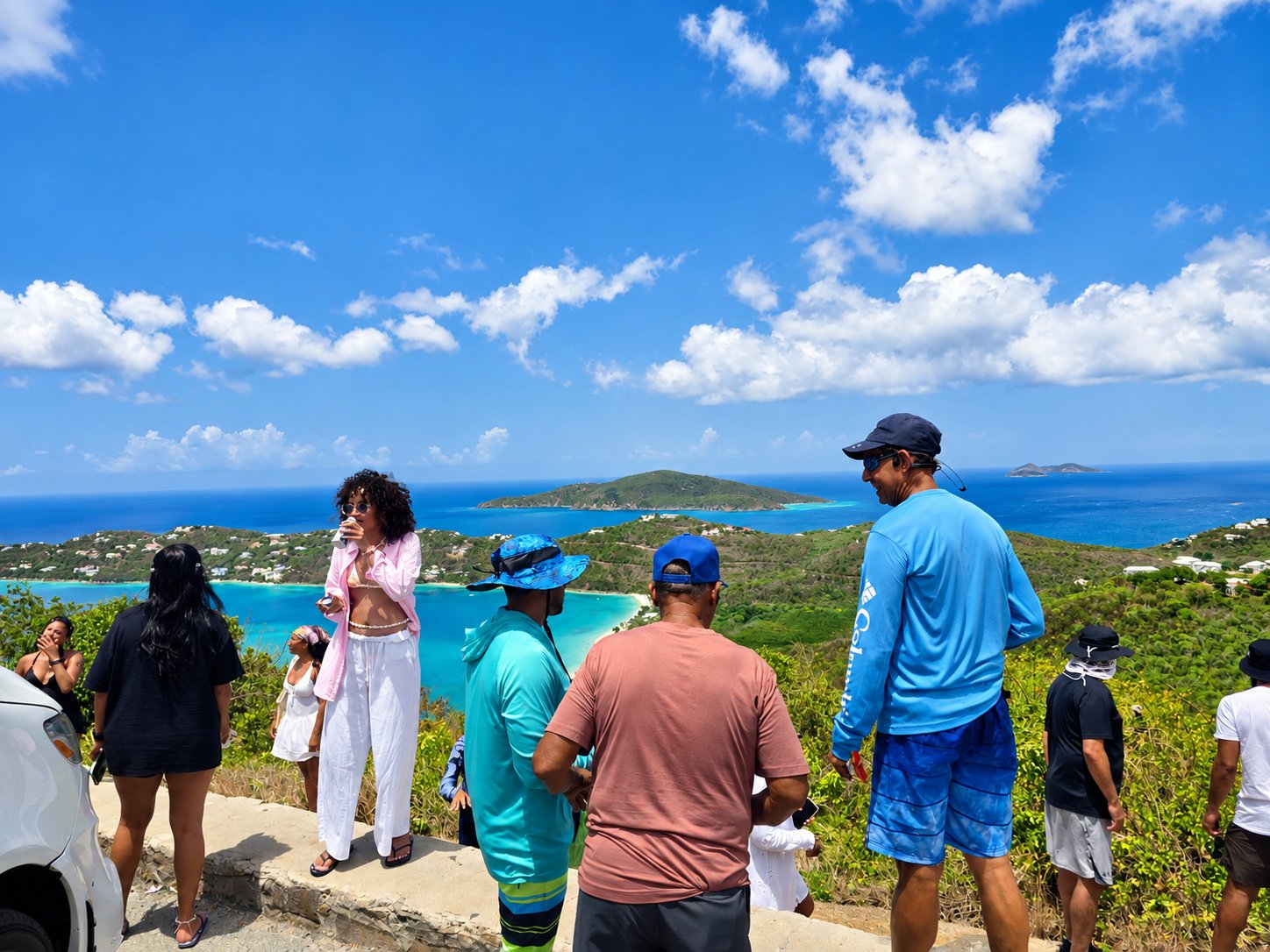 Visitors at a scenic St. Thomas overlook above a turquoise bay and green islands
